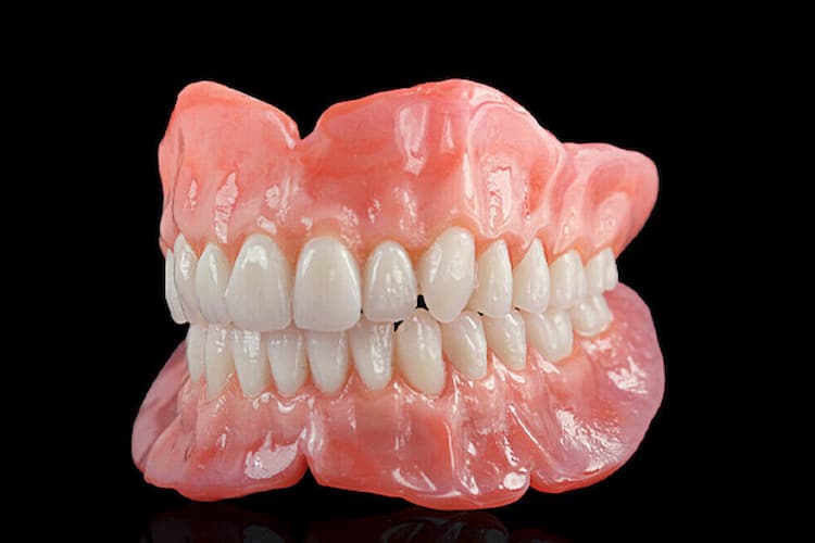 a customs denture model in a black background.