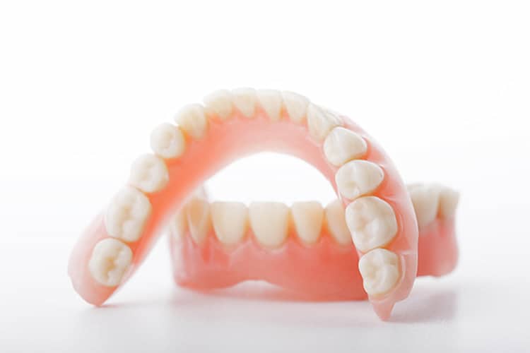 a denture model on  a white surface.