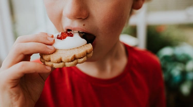 a boy who is eating sweets
