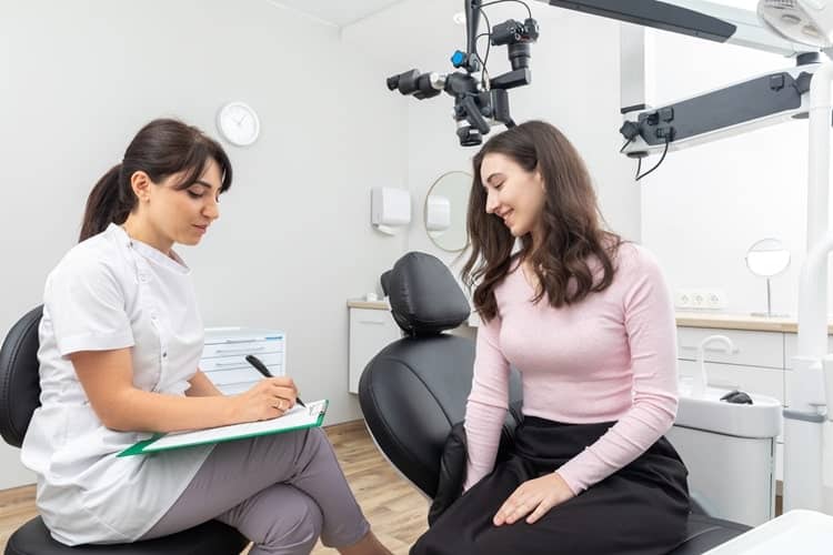a woman asking questions from dentist