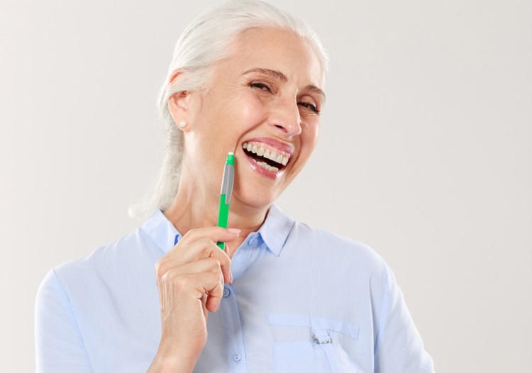 an old woman with a pen in her hands