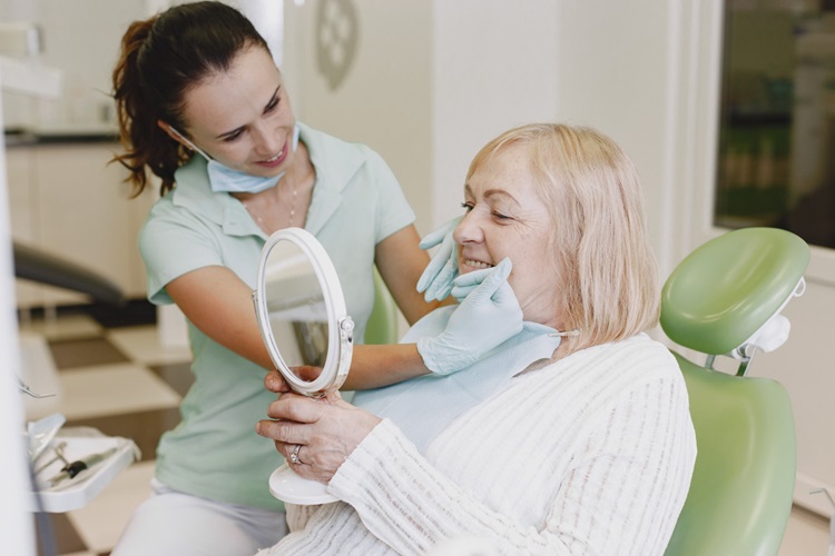 a woman visiting dentist for black spots on teeth
