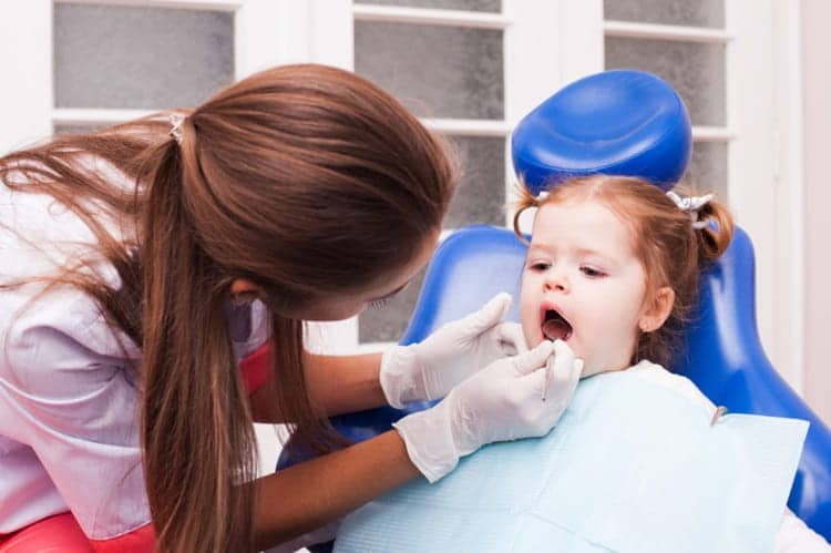 a dentist visiting a child